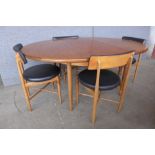 A G-Plan Fresco teak circular extending dining table and four chairs