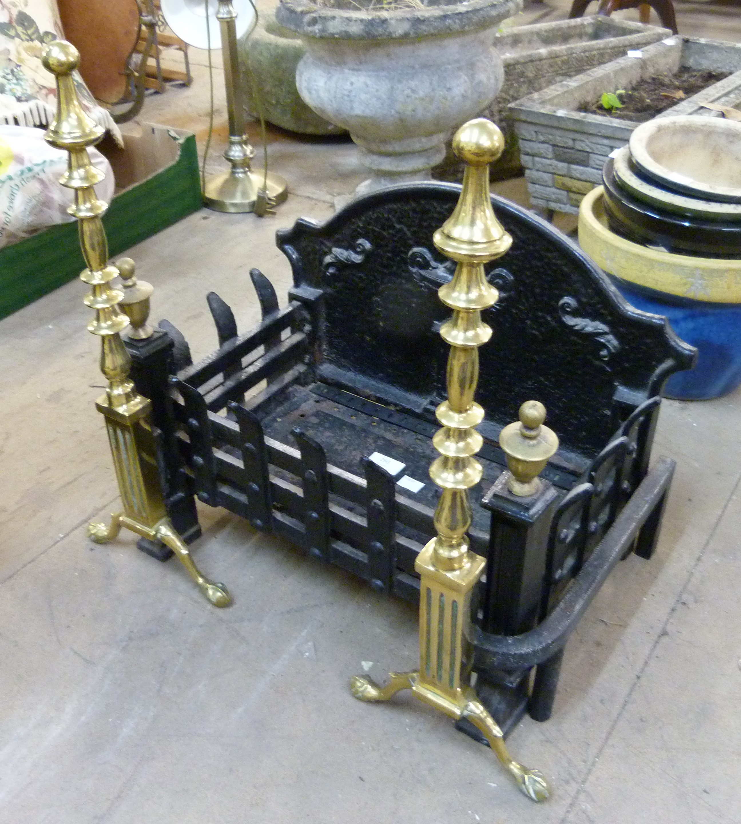 A cast iron fire grate and a pair of andirons