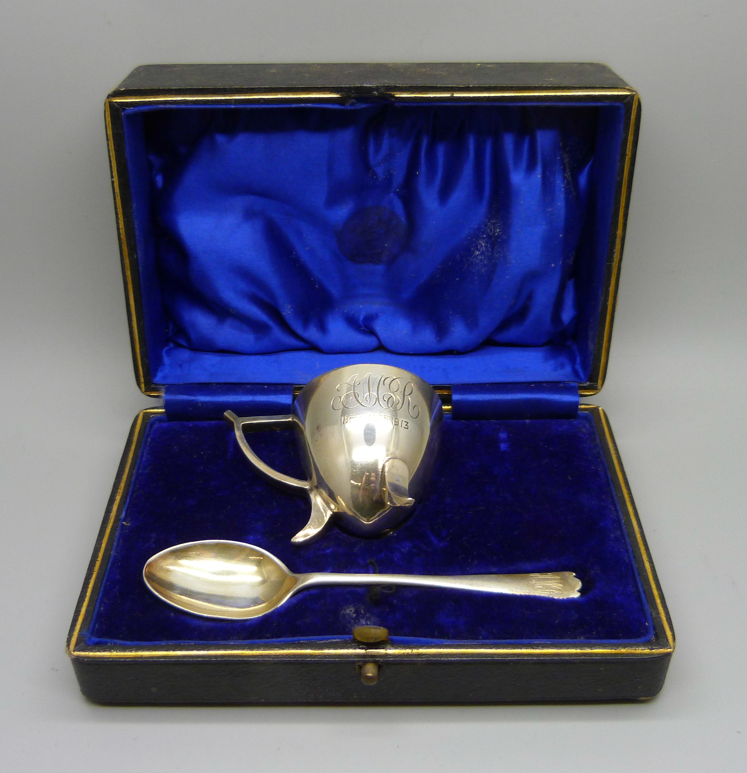 A silver egg cup and spoon set, with inscription, 58g