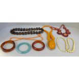 A collection of vintage plastic jewellery, bangles, and a bone necklace