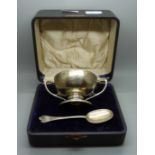 A silver two handled bowl and spoon set, engraved with initials and dated 1913, 235g, cased
