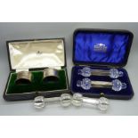 A pair of silver napkin rings in a Mappin & Webb box, 34g, cased, a pair of glass and silver knife