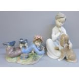Two Lladro figures of children with dogs, one with bird a/f (feathers)