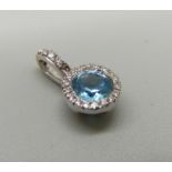 A hallmarked 18ct white gold, diamond and blue stone pendant, 1.2g