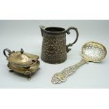 An Eastern silver jug, 108g, a Victorian pierced silver spoon, 28g, a silver mustard pot, 42g