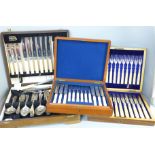 Cased cutlery; six fish knives and forks with servers, twelve pastry knives and forks in a