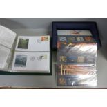 A set of twelve Millennium 2000 Royal Mail presentation packs and a folder of first day covers,