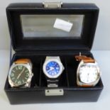 Three gentleman's wristwatches in display case