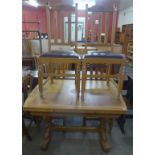 An oak draw-leaf table and four chairs