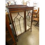 A mahogany bow front two door display cabinet