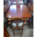A Regency style yew wood pedestal dining table and six Hepplewhite style chairs