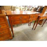 A yew wood serpentine four drawer console table