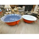 Two large orange enamelled bowls