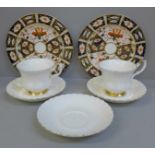 Two Royal Crown Derby 2451 pattern plates and Royal Albert Val D'Or cups and saucers