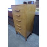 A teak chest of drawers