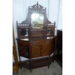 An Edward VII carved walnut mirrorback side cabinet