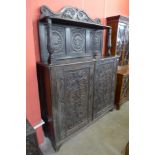 A 17th Century style Flemish carved oak side cabinet