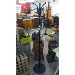 A black metal coat stand, ceiling light, desk lamp and a pair of vases