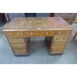 A Victorian mahogany and brown leather topped pedestal desk
