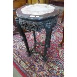 A late 19th/early 20th Century Chinese carved padouk wood and marble topped jardiniere stand