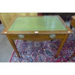 An Edward VII oak and green leather topped single drawer writing table