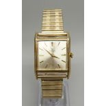 A 9ct gold cased Garrard wristwatch, the case back bears inscription dated 1964, 26mm case