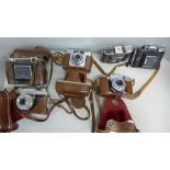 A collection of Zeiss cameras, all cased