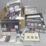 Stamps; a box of stamps on stock cards and in packets