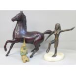 A metal model of a horse and two other figures