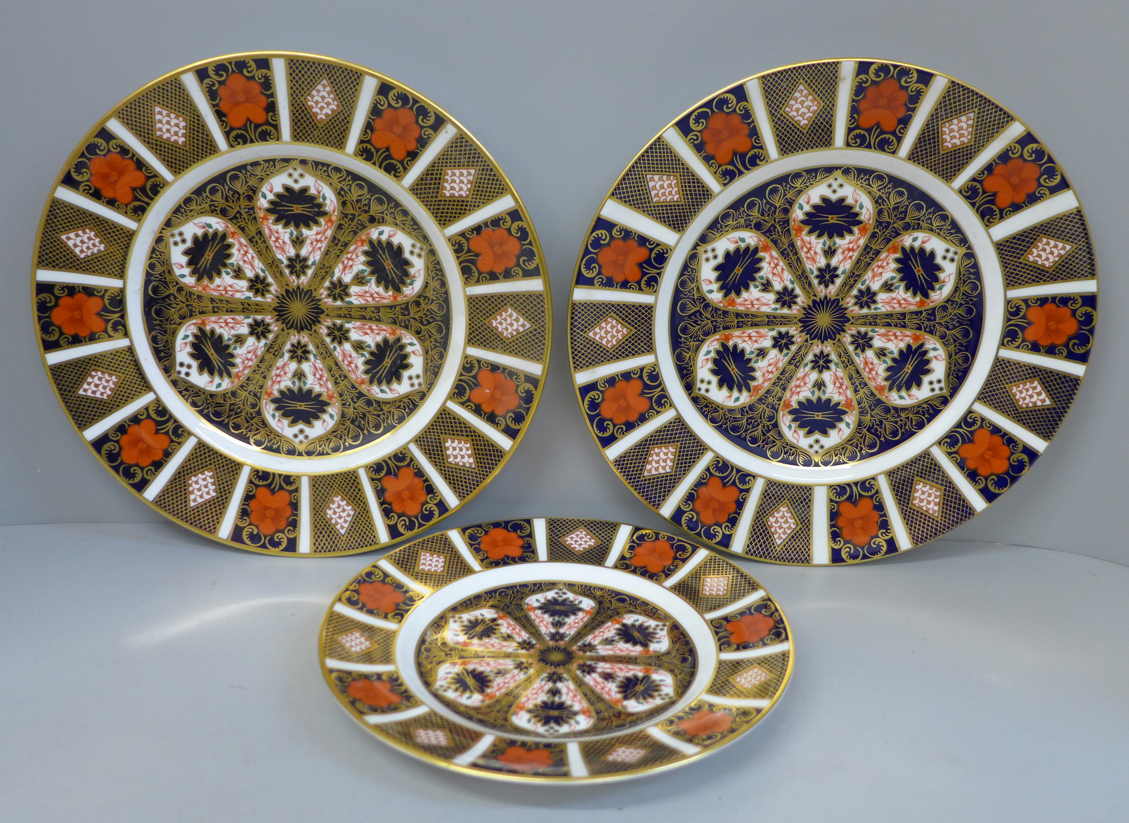 A pair of Royal Crown Derby Old Imari pattern plates and a medium side plate