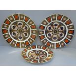 A pair of Royal Crown Derby Old Imari pattern plates and a medium side plate
