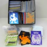 Pokemon cards; 50 Holographic with large quantity of protective sleeves and 25th Anniversary box