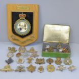 A mess hall plaque and a collection of military badges