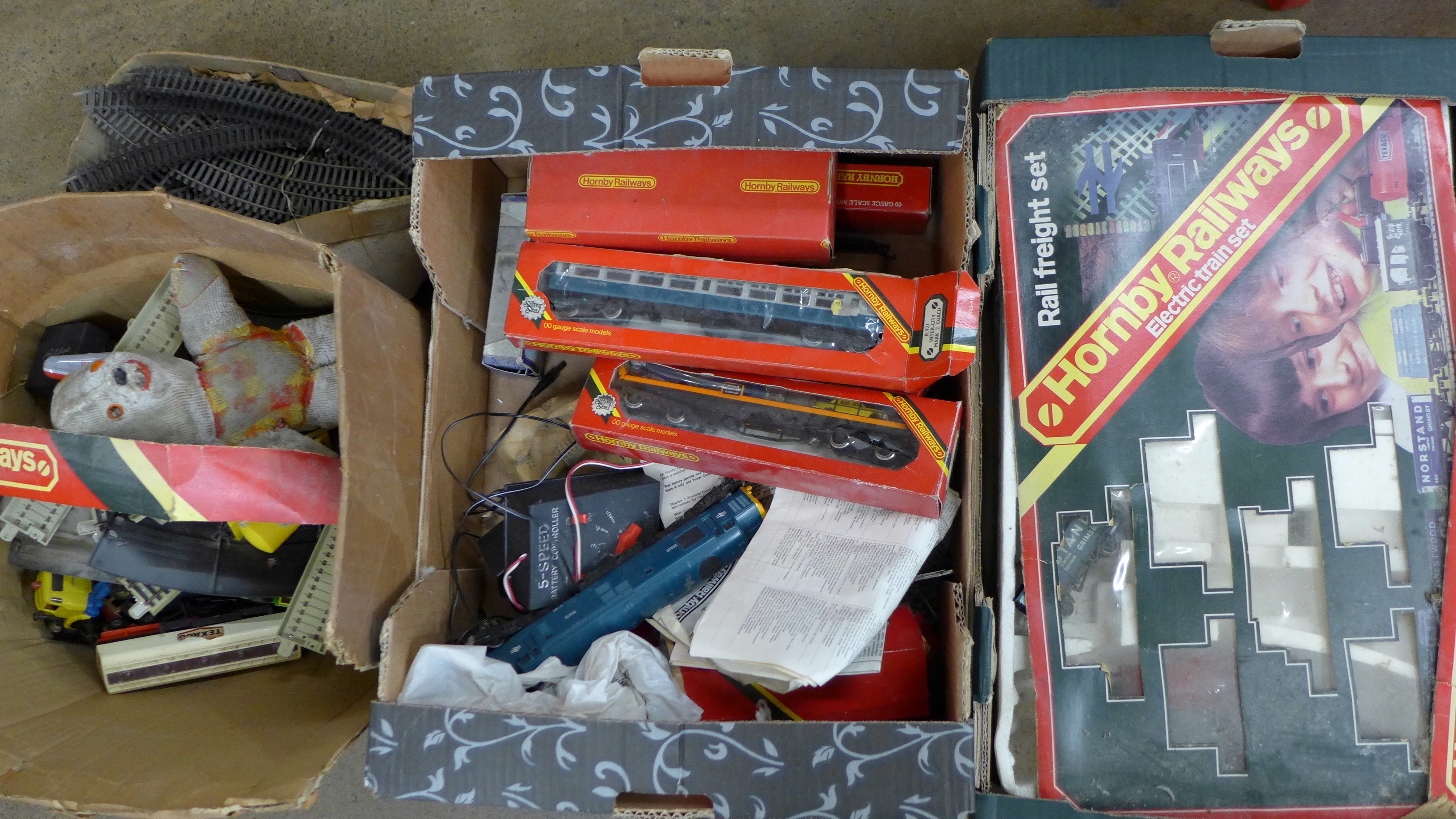 A Hornby The Rover train set, one other part train set, a box of model rail and a box of die-cast
