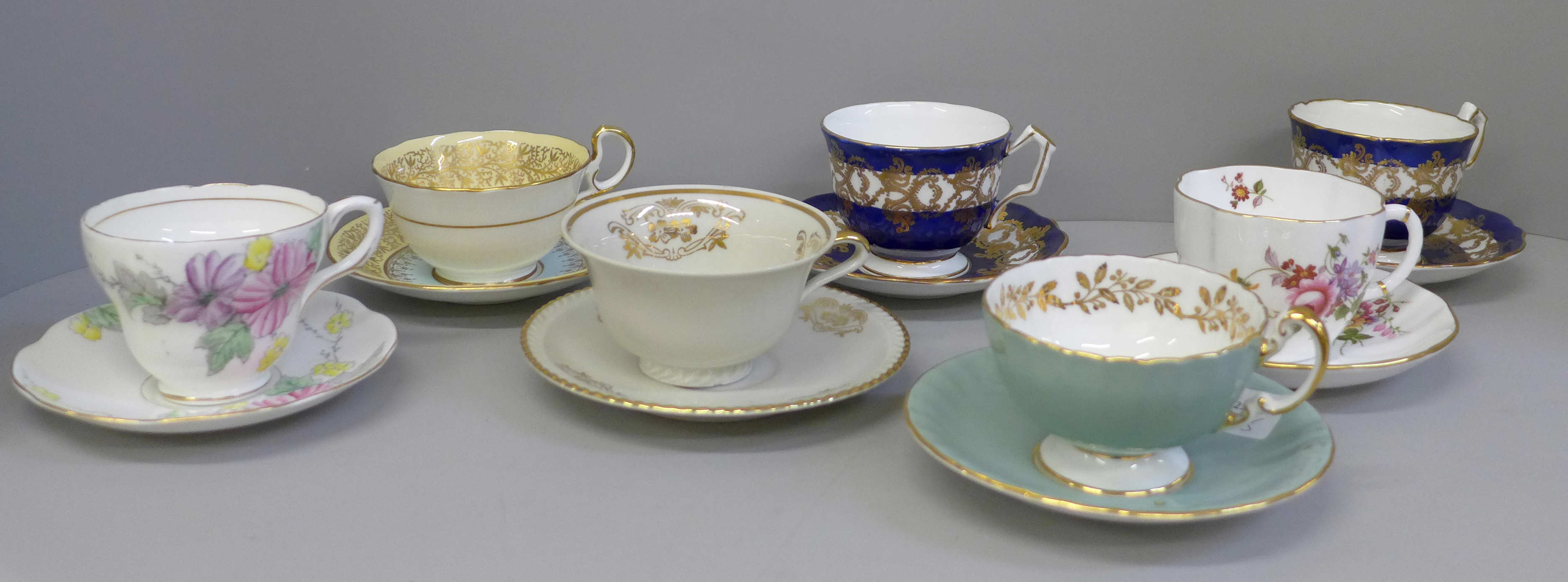 Seven cups and saucers including four Aynsley
