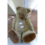 A large vintage Teddy bear with growler