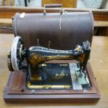 An early 20th Century cased Singer sewing machine