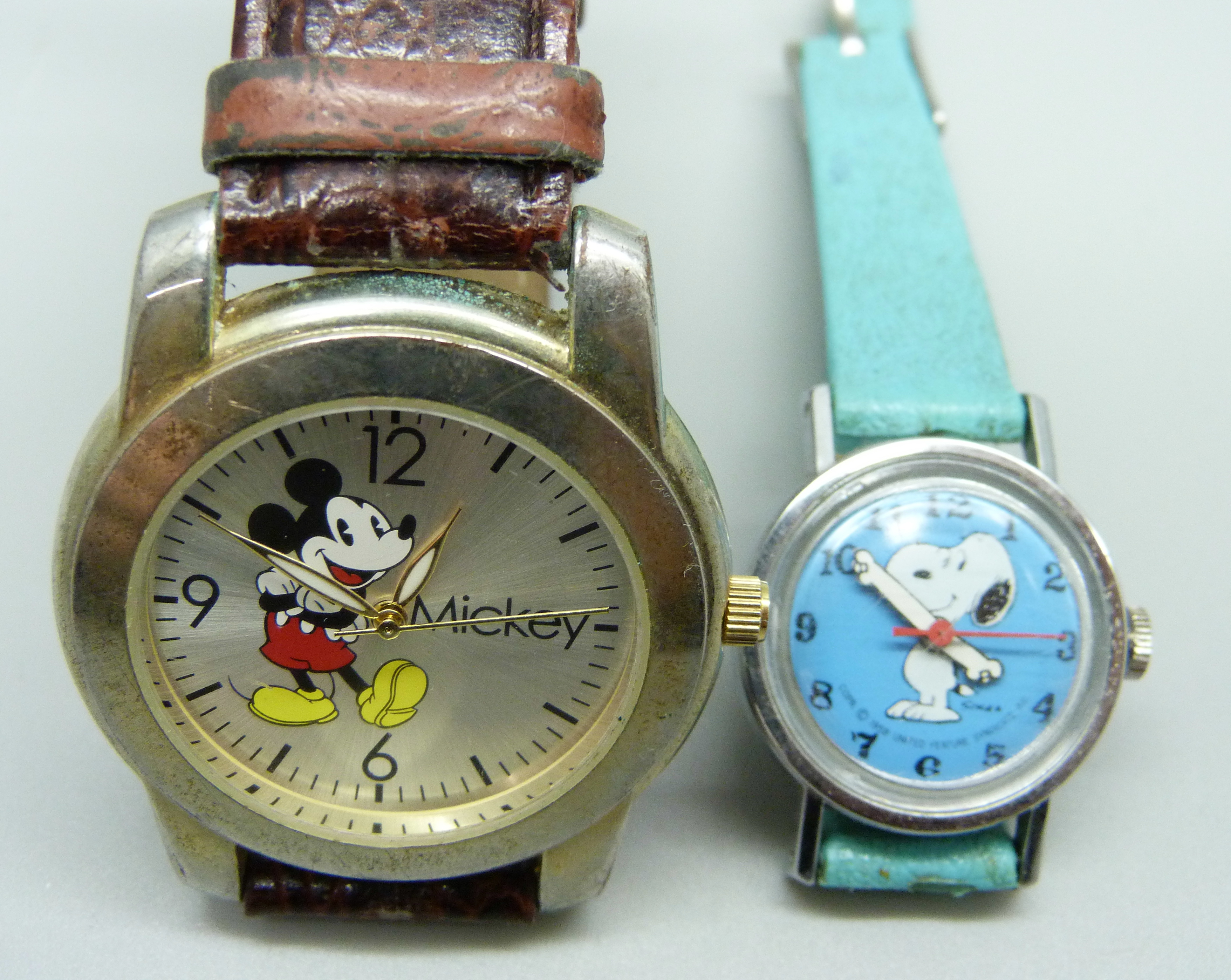 A Disney Mickey Mouse watch and a Snoopy watch