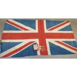 A Union Jack flag, military and other badges including one mounted