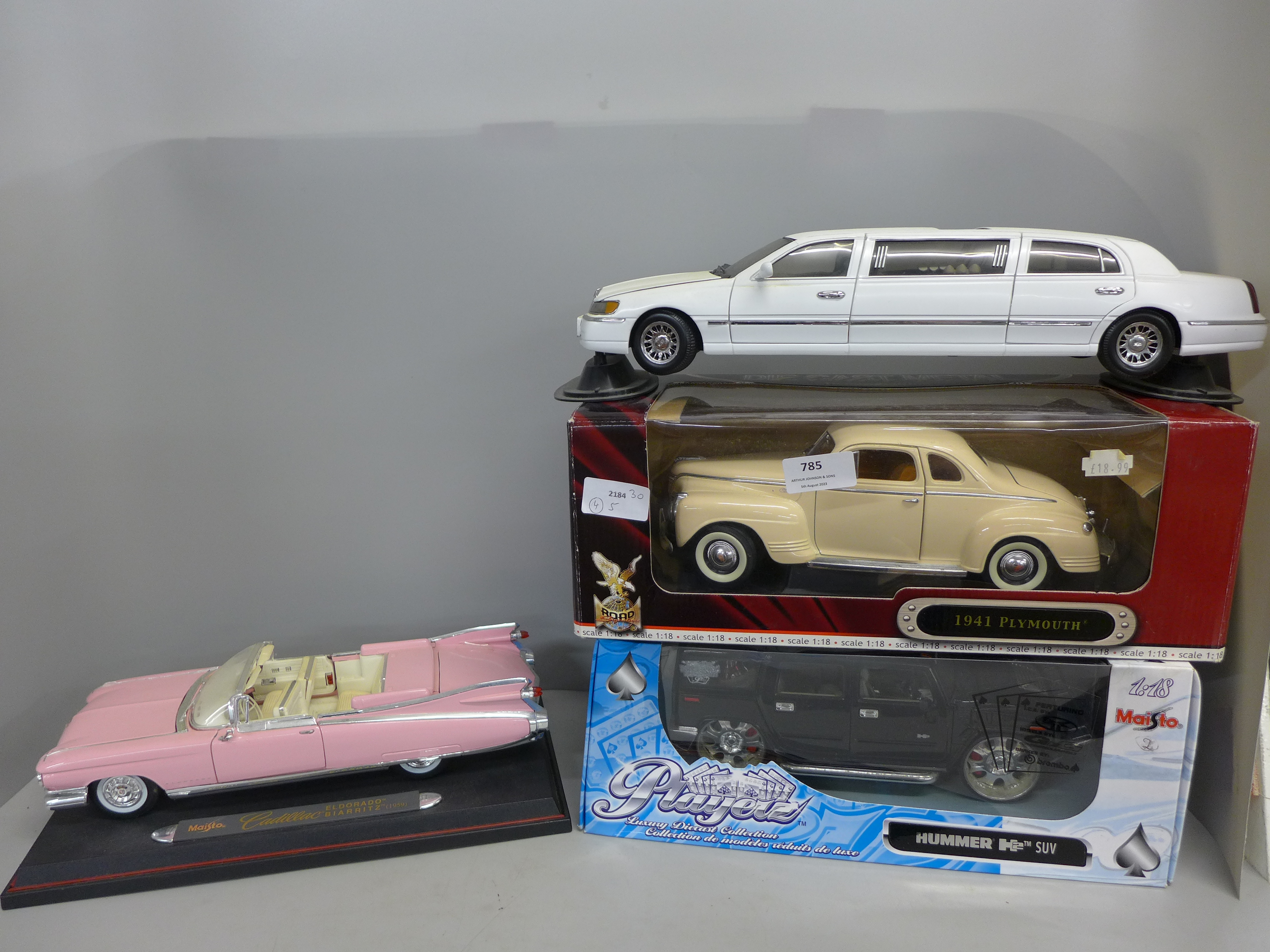 Four 1/18th scale model vehicles, Maisto Hummer SUV, Signature 1941 Plymouth, Maisto Pink Cadillac