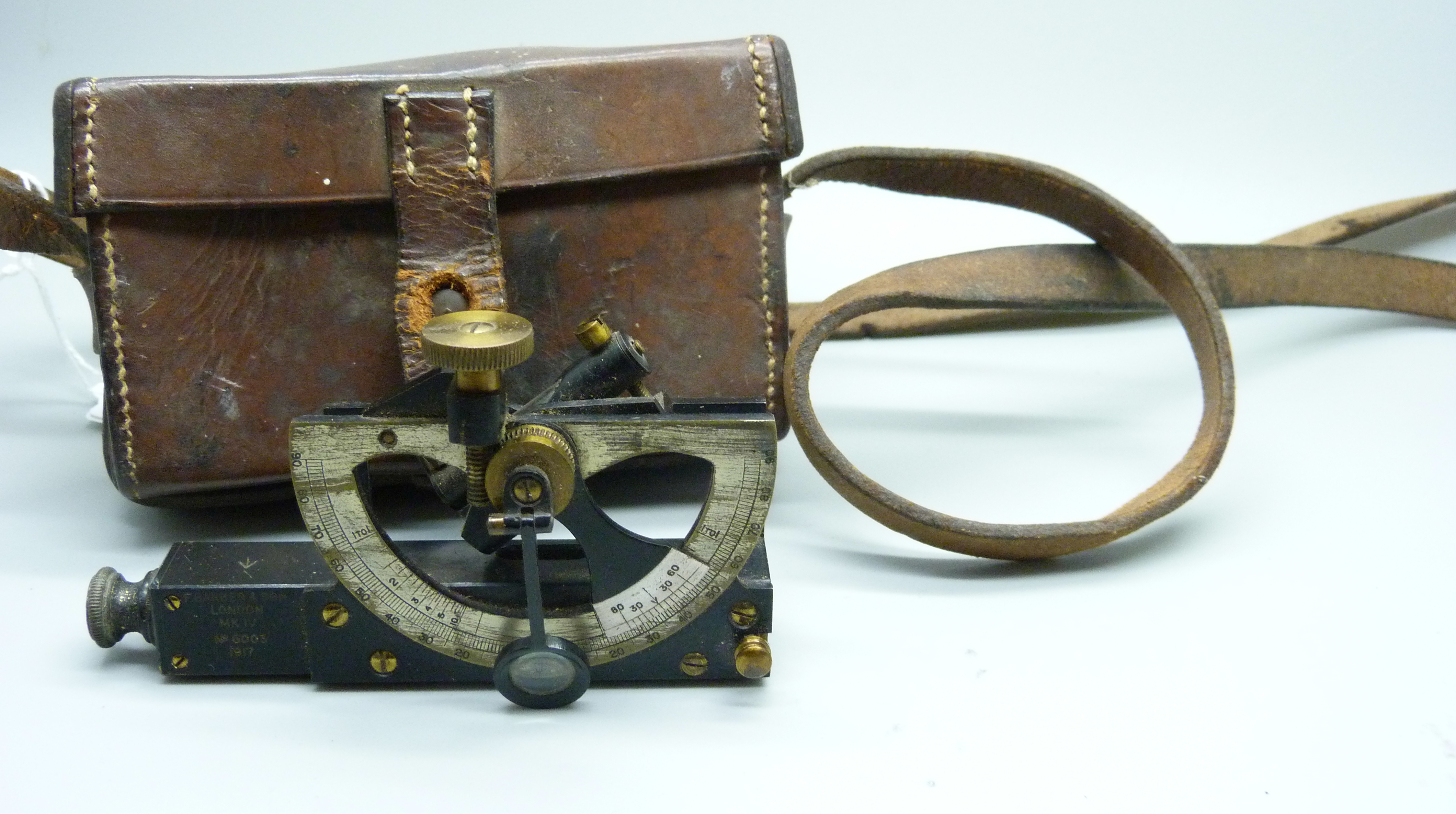 An antique clinometer, Barker & Son, London, Mk.IV, No. 6003, 1917, in a leather case marked Jacob's