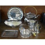 A collection of plated ware including a spirit kettle with stand, two tankards, a pair of dishes,