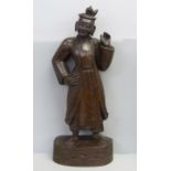 A mid 19th Century oriental wood carving of a figure, probably Burmese