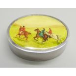 An oval silver pill box with hunting scene detail to the lid, 35g, 54mm wide