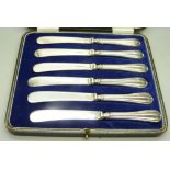A cased set of six butter knives, silver covered handles