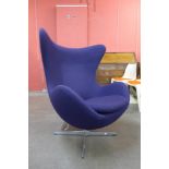 An Arne Jacobsen style chrome and purple fabric revolving lounge chair