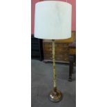 A cream Japanned standard lamp