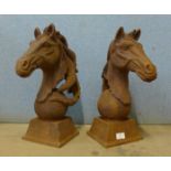 A pair of cast iron horse head garden ornaments