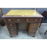 A George I style mahogany and tan leather topped kneehole desk