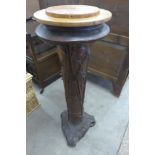 A French Art Nouveau style carved mahogany effect revolving jardiniere stand